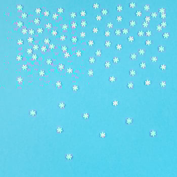Winter pattern made of small white snowflakes photo