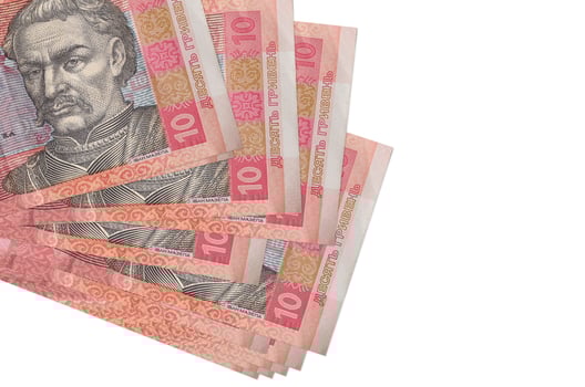 10 Ukrainian hryvnias bills lies in small bunch or pack isolated on white. Mockup with copy space. Business and currency exchange photo