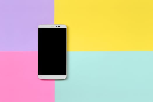 Modern smartphone with black screen on texture background of fashion pastel blue, yellow, violet and pink colors paper in minimal concept photo