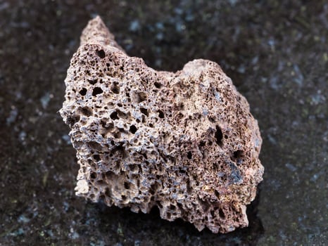 rough Pumice of basic composition stone on dark photo