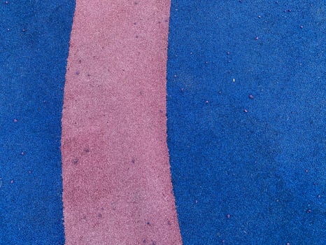 Blue and purple texture of the soft rubber surface of the safe cover of the sports playground for workout made of pressed fine rubber. The background. Texture photo