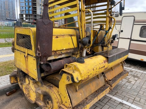 Yellow powerful old road small roller for asphalt paving and road repair at a construction site. Construction machinery photo