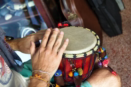 Hands of man playing African drum or djembe inside a music shop. Chiang Mai, Thailand. photo