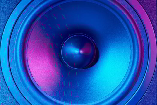 Sound audio speaker with neon lights on dark background photo