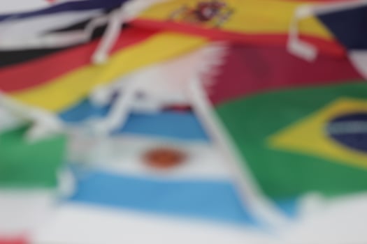 Leather soccer ball with international team flags of the participating countries in the championship tournament isolated on white background. Football equipment competitive game. World cup concept. photo