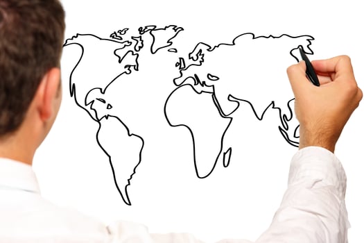 Young businessman drawing a world map photo