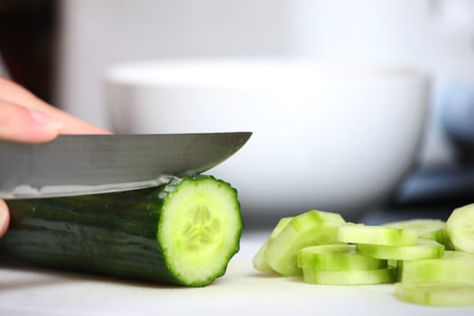 Cutting cucumber concept photo
