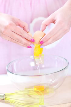 Cracking eggs close-up photo