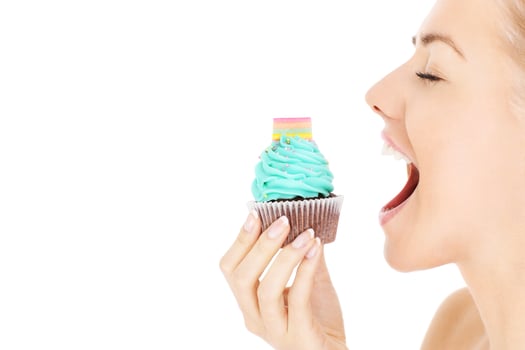 Woman biting a cupcake photo
