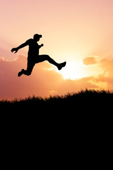 Vertical silhouette of a man jumping to the future. The concept of moving on to something better photo