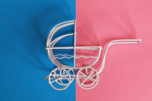 vintage baby stroller on pink and blue background. Boy or girl question photo