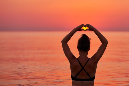 Young woman swimming in the sea on sunrise photo