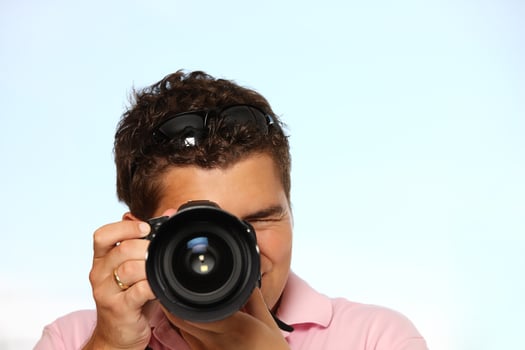 Young man with photo camera