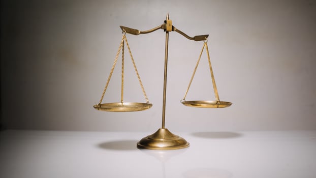 Business and lawyers discussing contract papers with brass scale on desk in office. Law, legal services, advice, justice and law concept photo