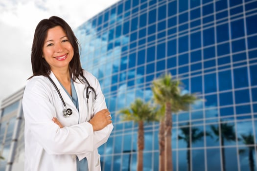 Attractive Hispanic Doctor or Nurse in Front of Building photo