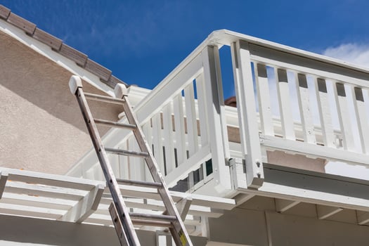 Construction Ladder Leaning on White House Deck photo