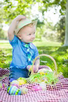 Cute Little Boy Outside Holding Easter Eggs Tips His Hat photo