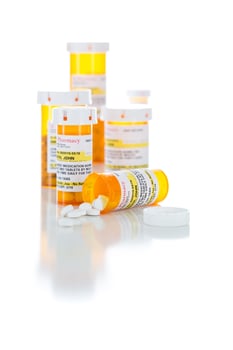 Non-Proprietary Medicine Prescription Bottles and Spilled Pills Isolated on White photo