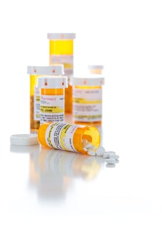 Non-Proprietary Medicine Prescription Bottles and Spilled Pills Isolated on White photo