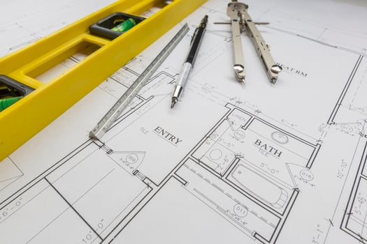 Construction Level, Pencil, Ruler and Compass Resting on House Plans photo