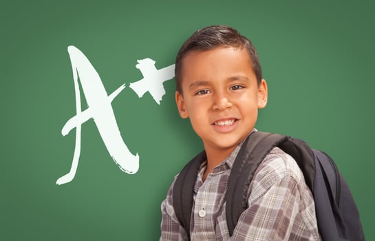 Hispanic Boy Up in Front of A Written on Chalk Board photo