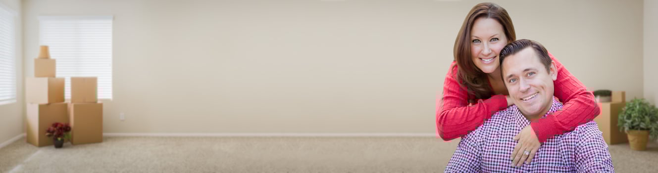 Young Caucasian Adult Couple Inside Room with Boxes Banner. photo