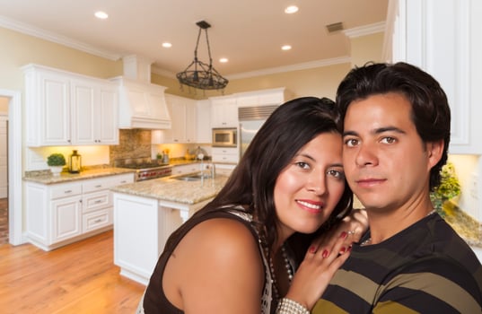 Hispanic Couple Inside Custom Kitchen Interior photo