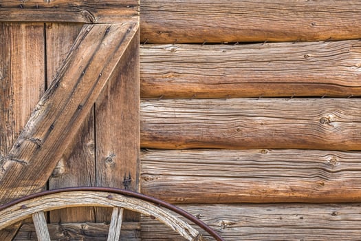 Abstract of Vintage Antique Log Cabin Wall and Wagon Wheel. photo