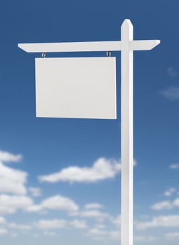 Blank Real Estate Sign Over A Blue Sky with Clouds. photo