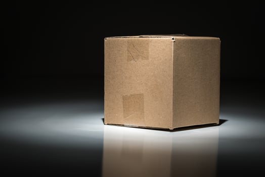 Blank Carboard Shipping Box Under Spot Light. photo