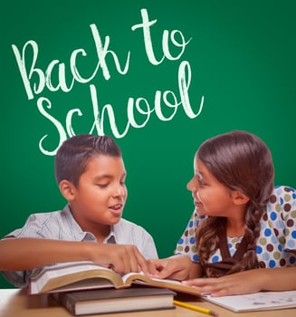 Back To School Written On Chalk Board Behind Hispanic Boy and Girl Having Fun Studying Together photo
