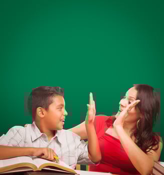 Blank Chalk Board Behind Hispanic Young Boy and Famale Adult Studying photo
