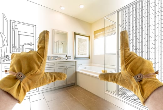 Male Contractor Hands Framing Completed Section of Bathroom Over Bathroom Drawing photo