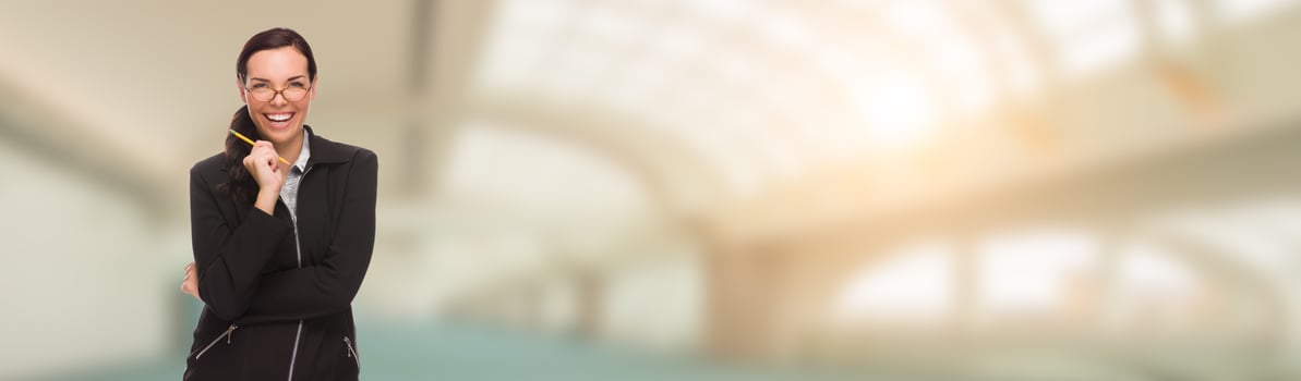 Laughing Mixed Race Businesswoman With Pencil Inside Building Banner photo