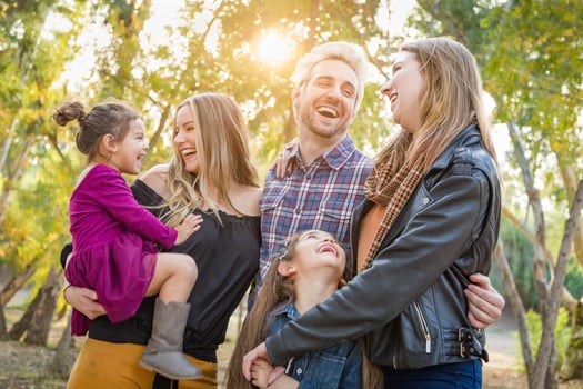 Mixed Race Family Members Having Fun Outdoors photo
