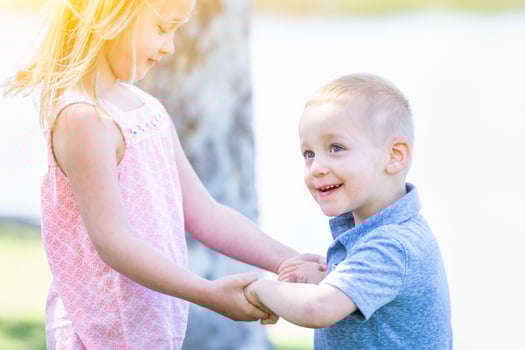 Young Brother and Sister Playing At The Park Togther photo