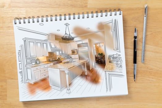 Sketch Pad on Desk with Drawing of Kitchen and Brush Stroke Showing Finished Construction Next To Pencil and Ruler. photo
