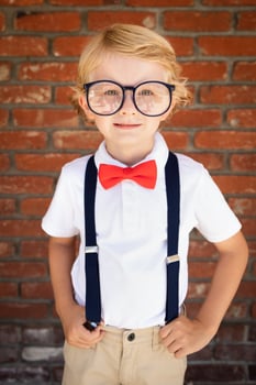 Cute Young Caucasian Boy Wearing Glasses and Red, White and Blue photo