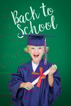 Young Caucasian Boy In Graduation Cap and Gown Against Green Chalkboard Background With Back To School photo