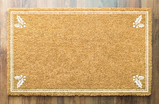Blank Holiday Welcome Mat With Holly On Wood Floor Background photo