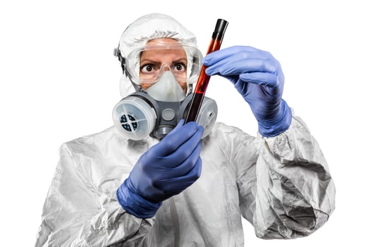 Woman In Hazmat Suit Holding Test Tube of Blood Isolated On White photo