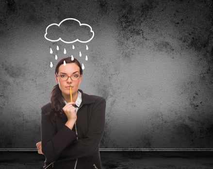 Rain and Cloud Drawn Above Head of Young Adult Woman With Pencil In Front of Wall with Copy Space photo