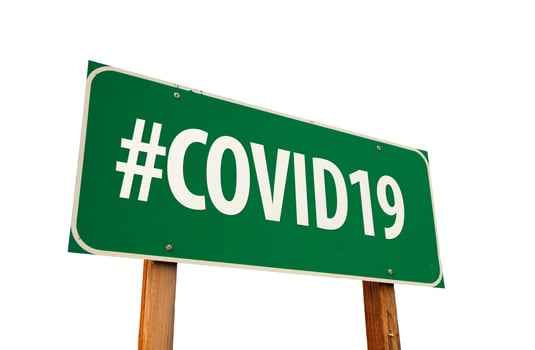 COVID19 Green Road Sign Isolated On A White Background photo