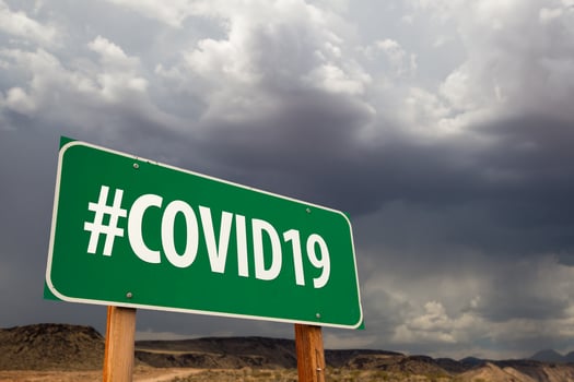 COVID19 Green Road Sign Against An Ominous Cloudy Sky photo