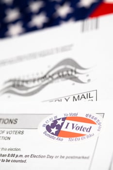 Vote-By-Mail Ballot Envelope and Voting Instructions Laying On American Flag photo