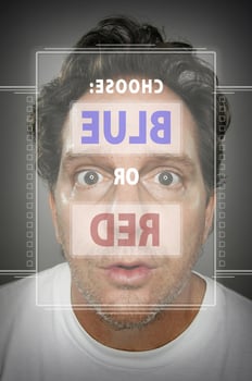 Dumbfounded Looking Man In Front of Touch Screen Choosing Blue or Red photo