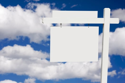 Blank Real Estate Sign on Clouds and Sky Background photo