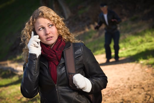 Pretty Young Teen Girl Walking with Man Lurking Behind Her photo