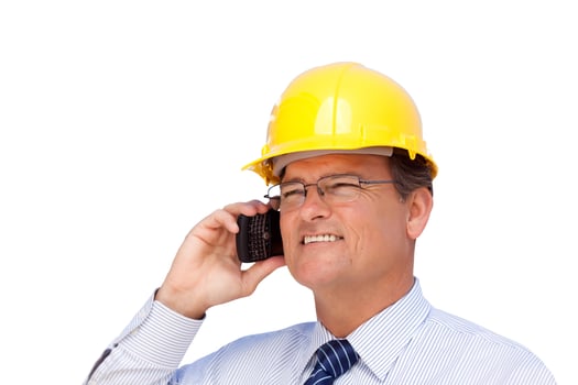 Contractor in Hardhat on His Cell Phone Isolated photo