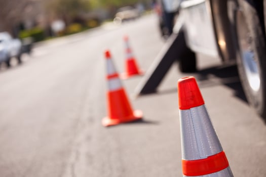Orange Hazard Cones and Utility Truck in Street photo